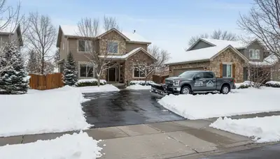 Cleared residential driveway after professional snow removal by landscaping experts in Littleton, CO