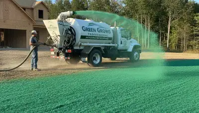 Hydroseeder truck spraying green slurry for new lawn installation in Littleton, CO landscaping project